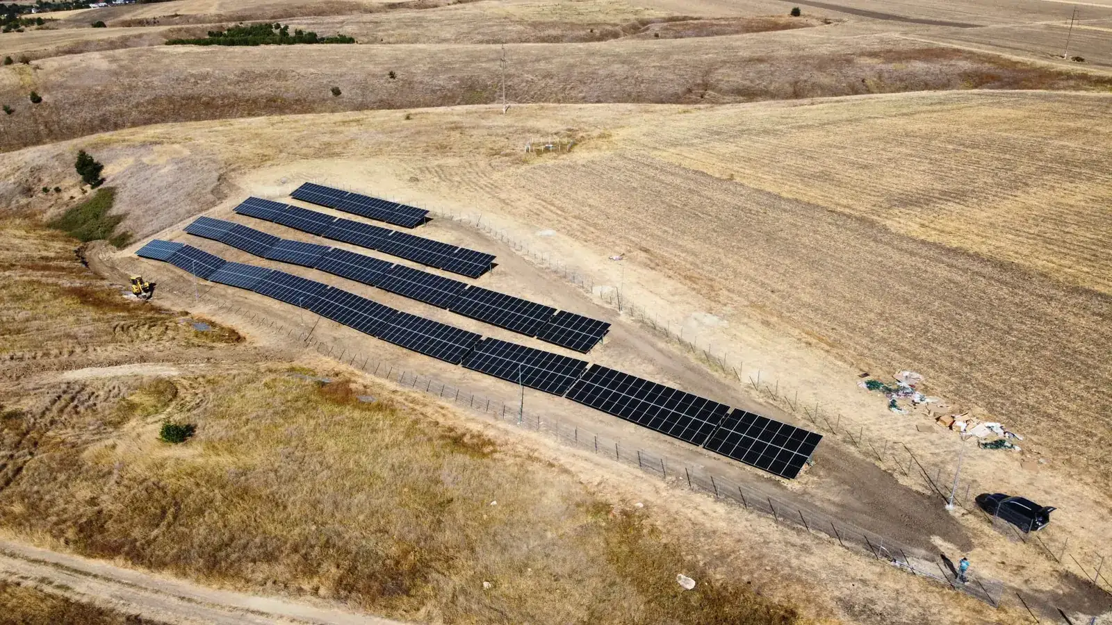 Solar panel rows following the hillside